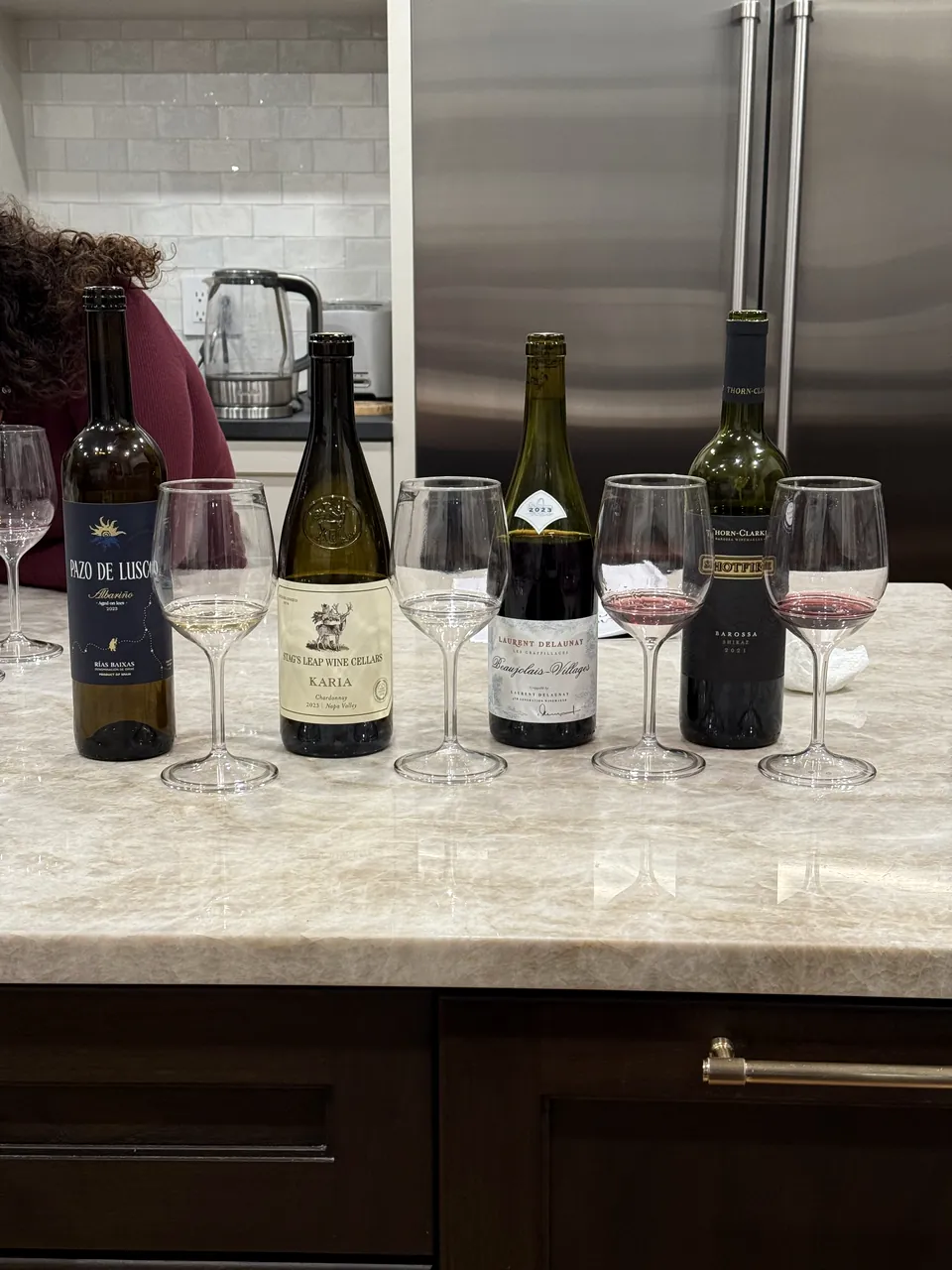 Four bottles and glasses set out for a tasting